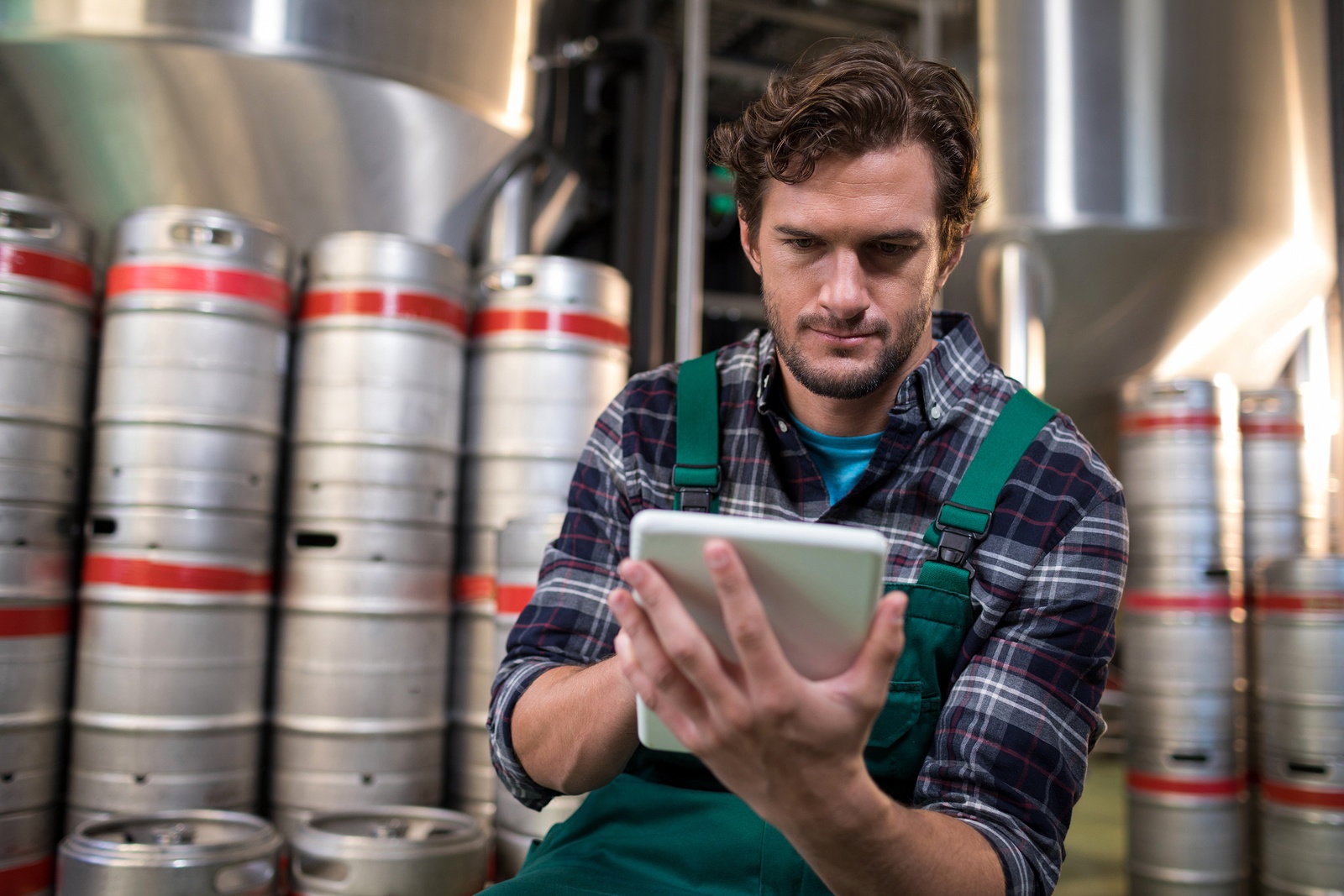 man on a tablet in a brewery