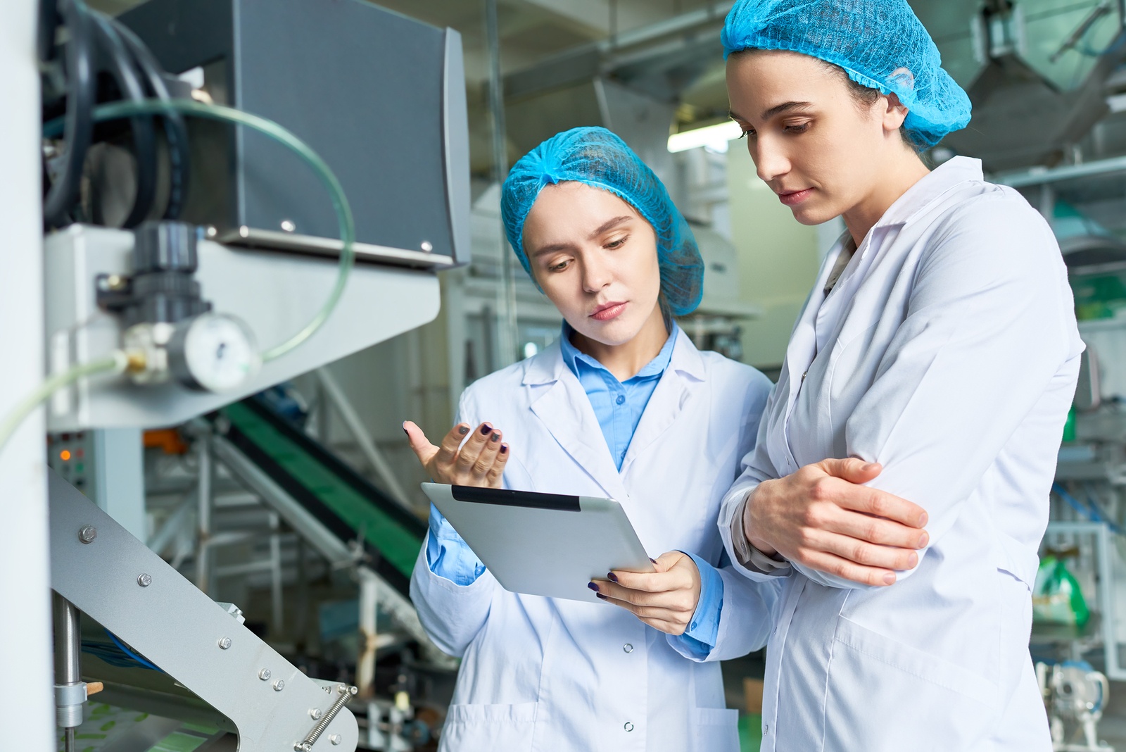 Bigstock  125354314 - Portrait Of Two Female Specialists Wearing Lab Coats Working At Modern Food Factory And Checking Pro